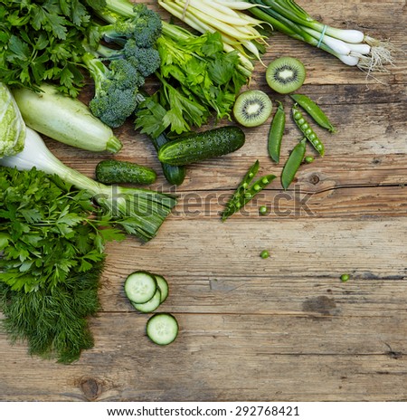 Raw detox green vegetable food set on wood table