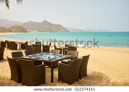 tropical restaurant on the beach with view over turquoise ocean