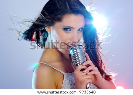 Rock star.Sexy Girl singing in retro mic