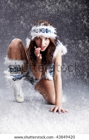 Winter wild woman on snow and grey background
