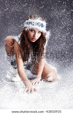 Winter wild woman on snow and grey background