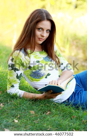 Young  woman studying in summer park