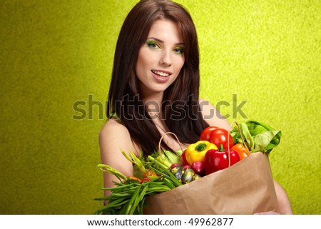 Woman with a shopping bag filled with nutritious fruit and vegetables