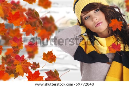Beautiful woman wearing hat and gloves and maple leaves