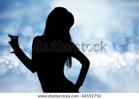 dancing silhouettes of women with champagne  in a nightclub