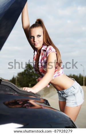 young sexy woman with her broken car.