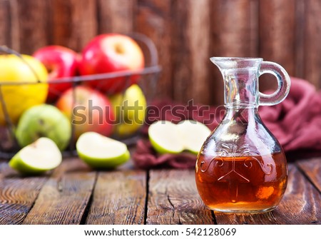 Similar – Image, Stock Photo Homemade apple vinegar in bottle with apples and green leaves on white background. Top view