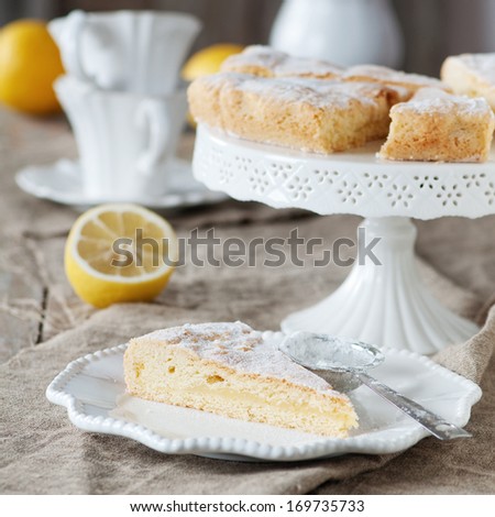 Homemade lemon cake with cream and fresh lemon, selective focus and square image