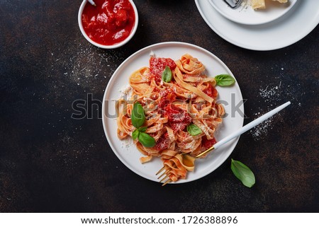 Similar – Image, Stock Photo Green tagliatelle pasta with ham, parmesan cheese, arugula and tomatoes on black plate