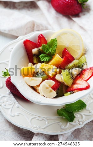 fruit salad with banana, kiwi, strawberry and orange, selective focus