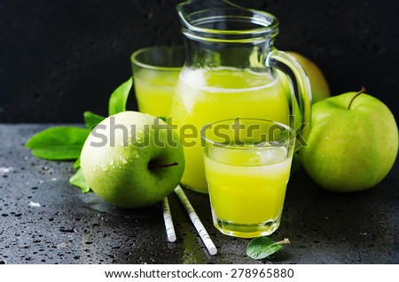 Fresh apple juice and green apples, selective focus