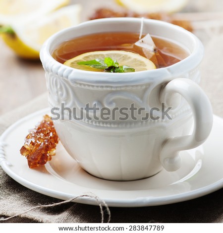 Hot tea with lemon and mint, selective focus and square image