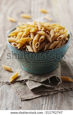 Integral raw pasta on the table, selective focus