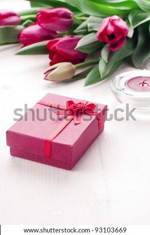 Romantic present with tulips and candle