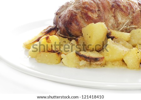rolled veal stuffed with potatoes in white plate