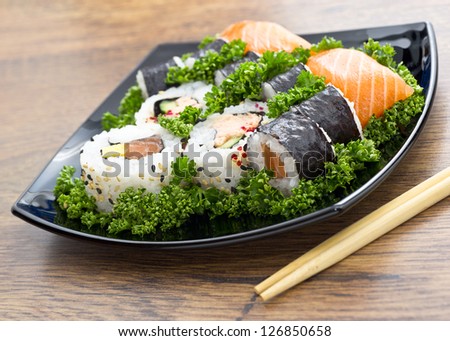 japan sushi in black plate on wooden table
