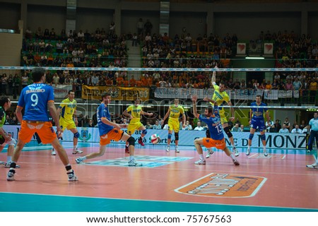 MONZA, ITALY - APRIL 20:  S. Creus Larry (Number 15 yellow) get a winner point  in Volley Gabeca Monza ( Blue) vs Volley Modena ( Yellow) -Italian Volley League on 2011 April, 20 in Monza (Italy)