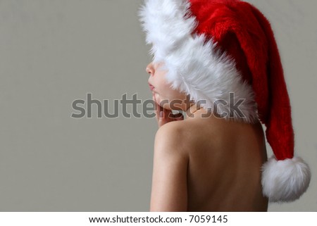 Toddler with a Christmas hat in deep thought