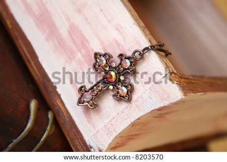 Copper Cross hanging from a wooden jewelery box