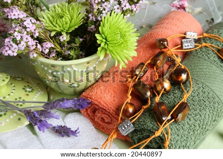 Spa Accessories setting with face cloths, beads and flowers