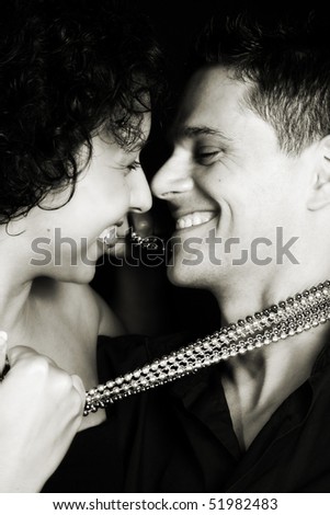 Beautiful young couple laughing with their faces close to one another