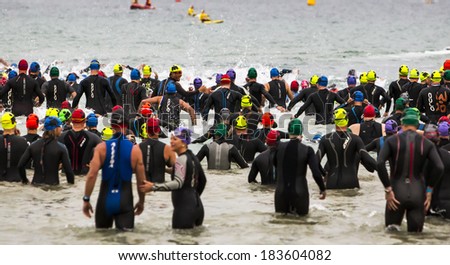 MELBOURNE, VICTORIA, AUSTRALIA - MARCH 23, 2014 - The age group category Ironman athletes begin their 3.8km swim leg on March 23, 2014.
