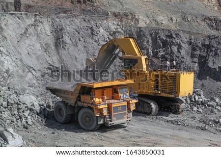 Open pit mining of iron ore and magnetite ores.Loading the iron ore into heavy dump truck at the opencast mining. Foto d'archivio © 