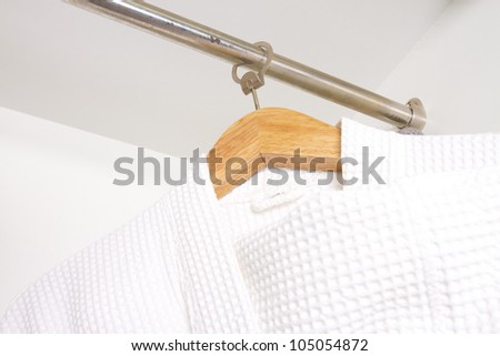 bathrobe, white bathrobe hanging in the closet
