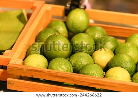 lime, green lime in wood box selling at the market, Thailand