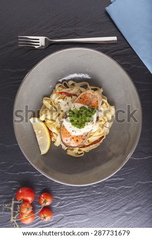 Pasta salmon, fresh seasoning pasta with grilled salmon steak in a decor dish