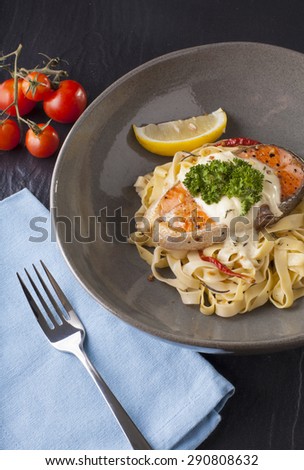 Pasta salmon fresh seasoning pasta with grilled salmon steak in a decor dish