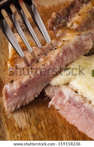 steak, a prepared piece of steak cut with blue cheese sauce on dining table decorated