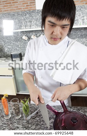 Chef sharpening a knife, Asian young chef sharpening a knife brutally.