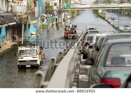 BANGKOK, THAILAND - NOV 12: People traveling together by truck after the city was flooded on November 12, 2011 in Bangkok, Thailand.