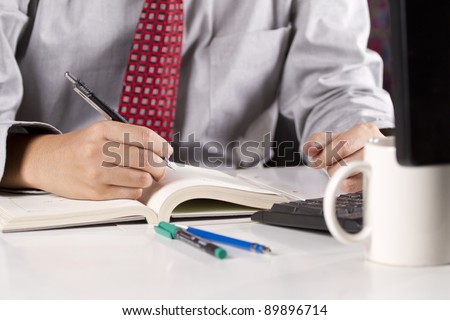 make agenda, a male hand writing schedule memo on the organize book.