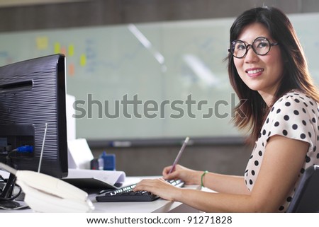working lady, Asian girl wear glasses and polka dot shirt working in the office.
