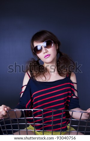 cute and cool, female model pose with chair in cute and cool style.
