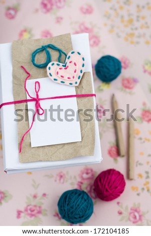 Old notebook for love notes and bright yarn balls