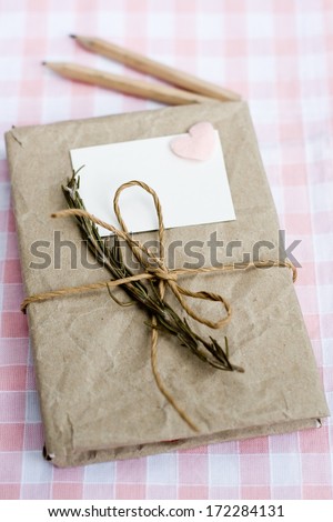 Old notebook with a dry branch of rosemary for love notes