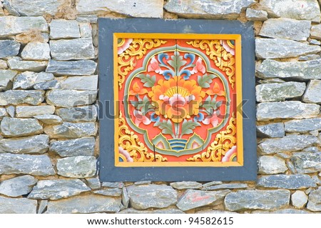 Bhutan Timber Logo bury in the stone wall