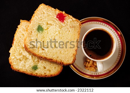 Close-up with a cup of coffee and two slices of sponge cake with Turkish delight