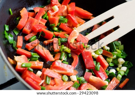 Cooking - peppers and onion in a pan