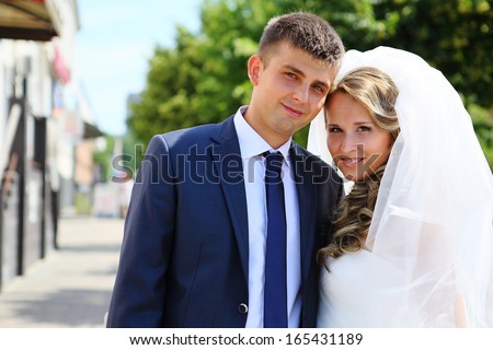 Portrait of the bride and groom on a city street, wedding