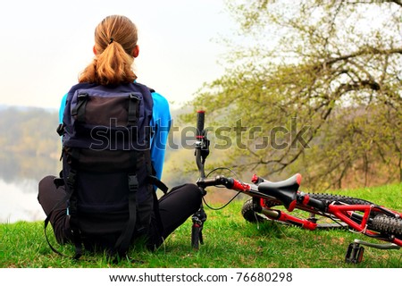Woman cyclist on a halt. Travel and outdoor recreation.