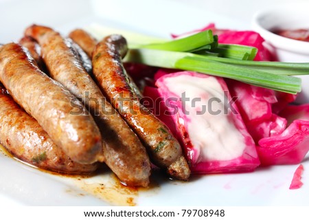 Sausages homemade with sauerkraut and onions. Fatty meat food