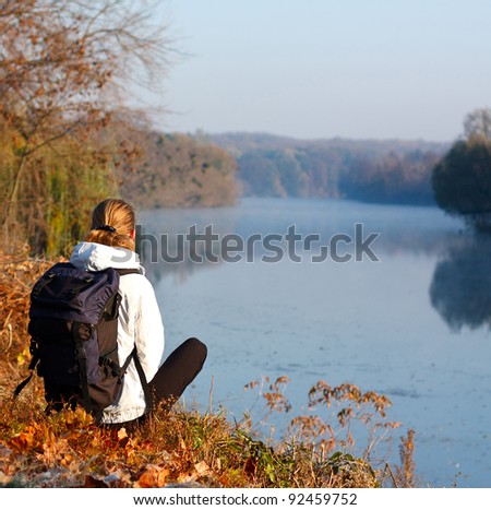 Woman traveler enjoy the recreation on the river-side. Beautiful scenic view