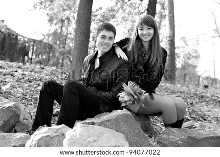 Young beautiful happy couple in love against the background of nature. Black and white