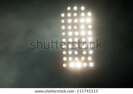 stadium lights at night with smoke