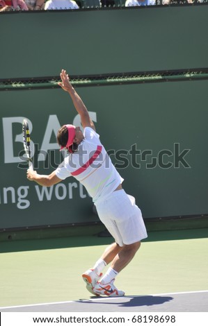 INDIAN WELLS, CALIFORNIA - MARCH 14.  Spain\'s Rafael Nadal prepares to serve during an early round doubles match March 14, 2010 at the BNP Paribas Open.