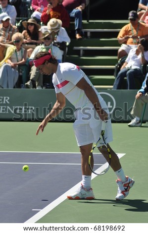 INDIAN WELLS, CALIFORNIA - MARCH 14.  Spain\'s Rafael Nadal prepares to serve during an early round doubles match March 14, 2010 at the BNP Paribas Open.